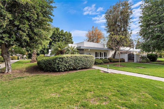964 Calle Aragon Unit D, Laguna Woods, CA 92637 - view of front facade featuring a front yard and a gate