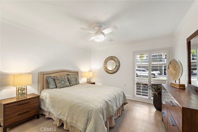 964 Calle Aragon Unit D, Laguna Woods, CA 92637 - bedroom with wood finished floors, crown molding, multiple windows, and baseboards