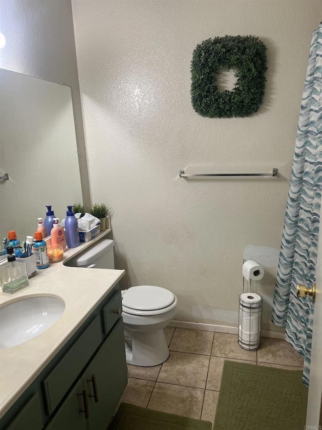 full bath featuring curtained shower, vanity, toilet, and tile patterned floors