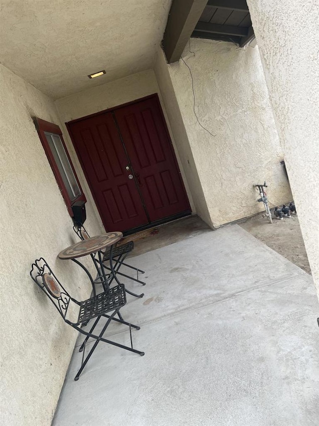doorway to property featuring stucco siding