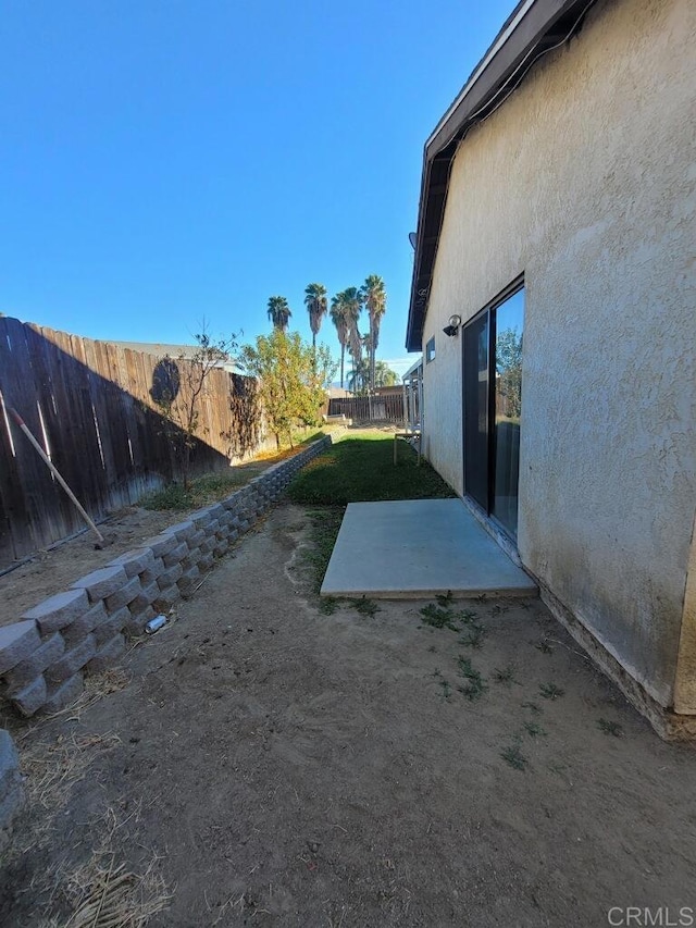 view of yard featuring a patio and a fenced backyard