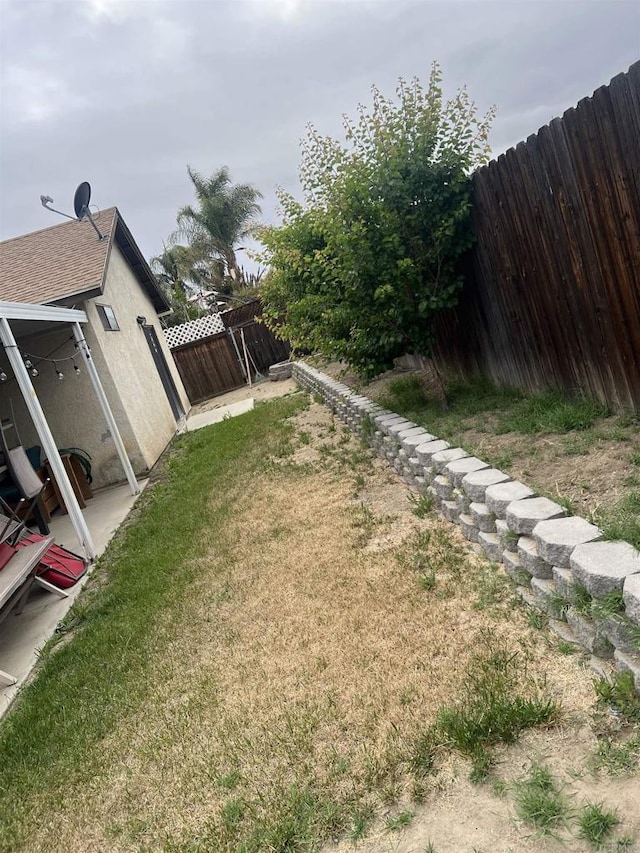 view of yard featuring a patio and a fenced backyard