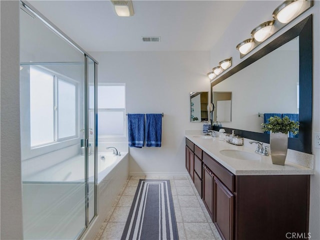 bathroom featuring visible vents, a stall shower, a bath, and a sink