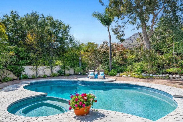 1480 Forest Knoll Dr, Oak Park, CA 91377 - view of pool with a patio, a pool with connected hot tub, fence, and a mountain view