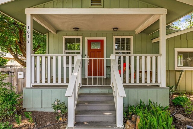 doorway to property featuring covered porch and board and batten siding