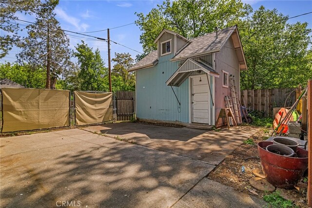 view of outbuilding with fence