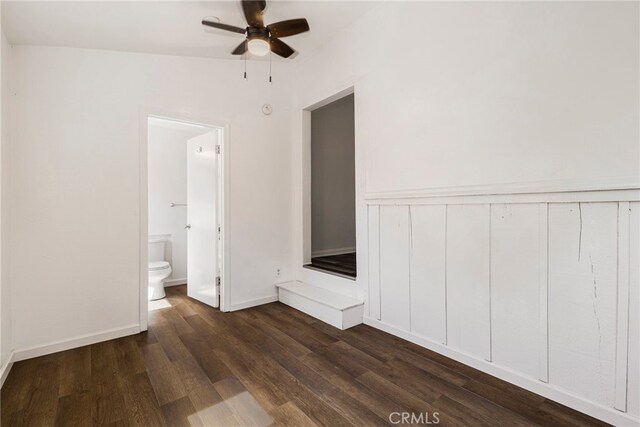 empty room with dark wood-style flooring and a ceiling fan