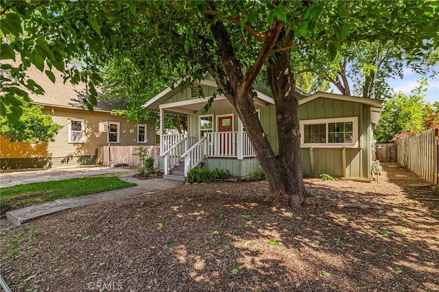 1617 Hemlock St, Chico, CA 95928 - view of front of house with a porch, fence, and board and batten siding