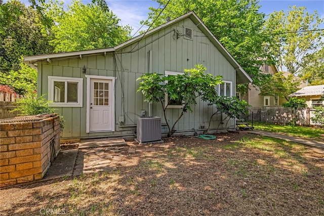 rear view of house featuring fence and cooling unit
