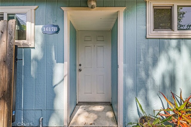property entrance featuring board and batten siding