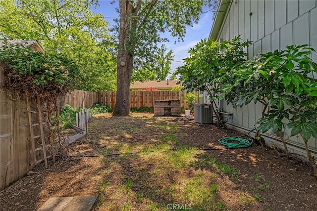 view of yard featuring a fenced backyard and central air condition unit