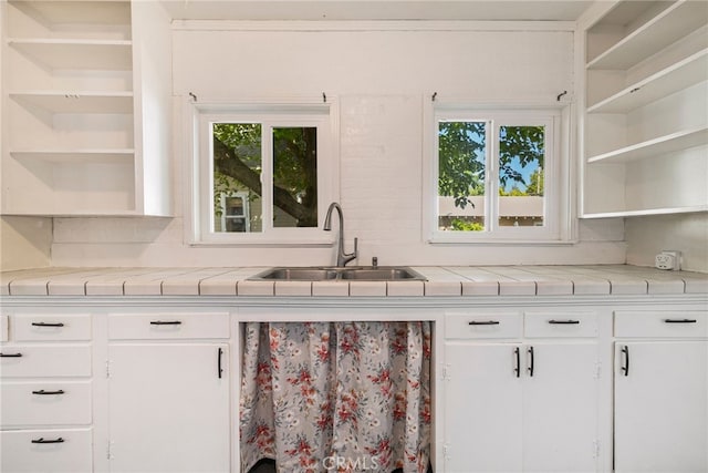 1617 Hemlock St, Chico, CA 95928 - kitchen featuring open shelves, a sink, plenty of natural light, and white cabinetry