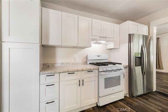 kitchen with white gas range, stainless steel refrigerator with ice dispenser, dark wood finished floors, under cabinet range hood, and white cabinetry