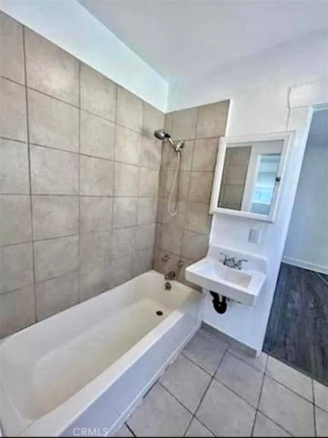 full bath featuring shower / bathtub combination, tile patterned flooring, and a sink