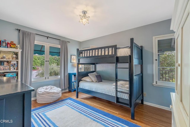 bedroom with wood finished floors and baseboards