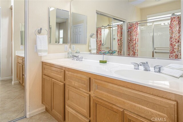 bathroom with tile patterned flooring, double vanity, and a sink