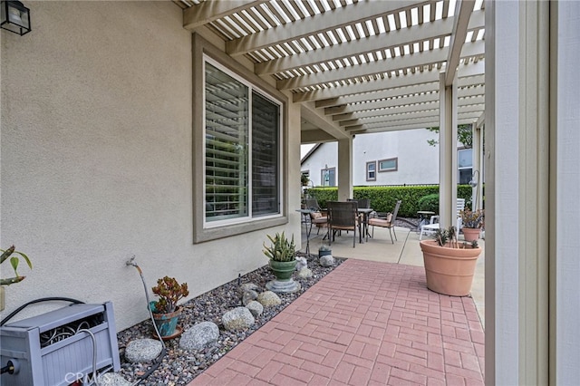 view of patio with outdoor dining area and a pergola