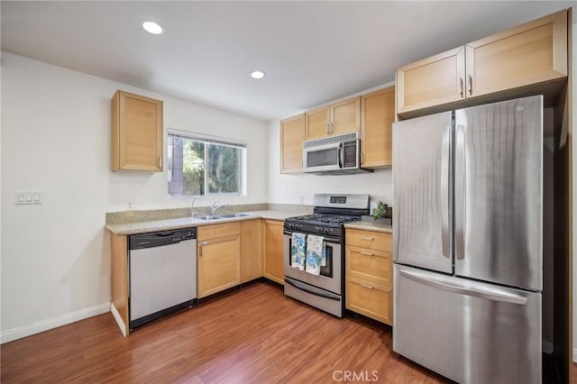 14618 Gilmore St Unit 8, Van Nuys, CA 91411 - kitchen with a sink, stainless steel appliances, light brown cabinetry, light countertops, and wood finished floors