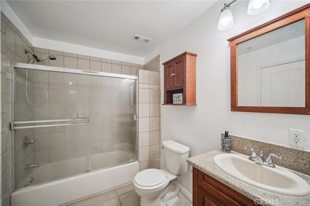 14618 Gilmore St Unit 8, Van Nuys, CA 91411 - bathroom with shower / bath combination with glass door, vanity, tile patterned floors, toilet, and visible vents