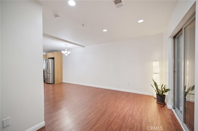 14618 Gilmore St Unit 8, Van Nuys, CA 91411 - empty room featuring visible vents, light wood-type flooring, recessed lighting, and a notable chandelier