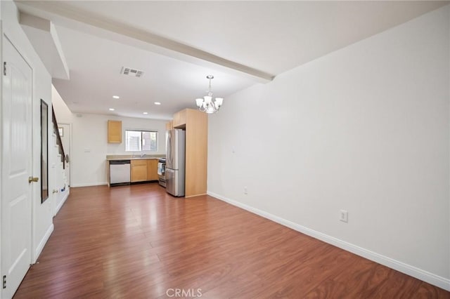 14618 Gilmore St Unit 8, Van Nuys, CA 91411 - unfurnished living room featuring recessed lighting, dark wood-style flooring, a notable chandelier, visible vents, and baseboards
