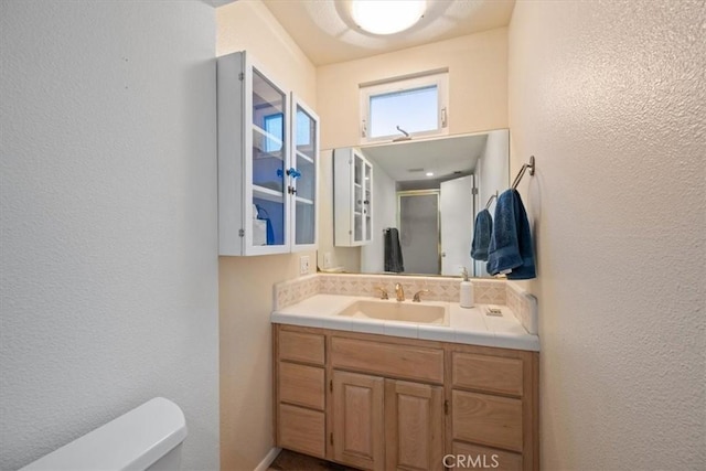 259 Saint Andrews Way, Lompoc, CA 93436 - bathroom with vanity, a textured wall, and a shower stall