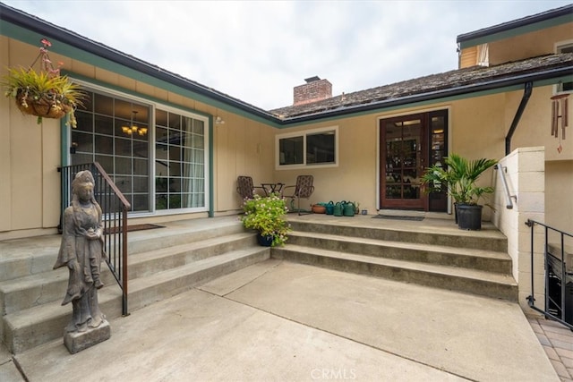 259 Saint Andrews Way, Lompoc, CA 93436 - doorway to property featuring a chimney and stucco siding