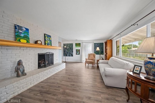 259 Saint Andrews Way, Lompoc, CA 93436 - living area featuring a brick fireplace and wood finished floors