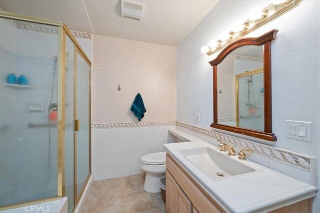 259 Saint Andrews Way, Lompoc, CA 93436 - full bath with vanity, a shower stall, tile walls, and a wainscoted wall