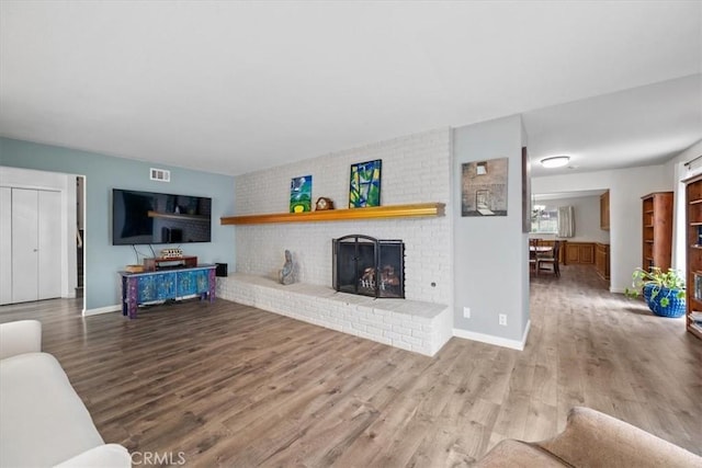 259 Saint Andrews Way, Lompoc, CA 93436 - living area featuring wood finished floors and a brick fireplace