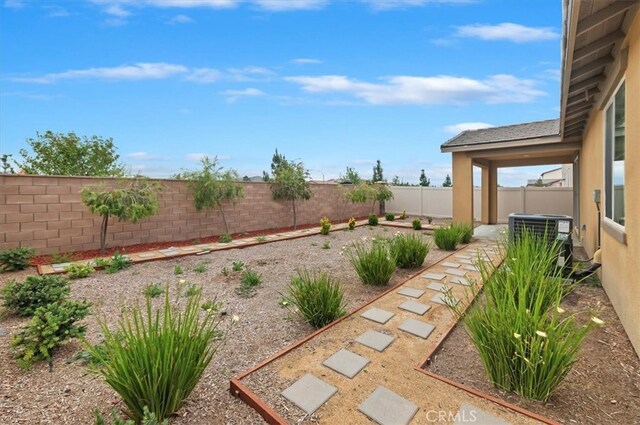 467 Daniella Way, Perris, CA 92570 - fenced backyard featuring cooling unit and a patio area