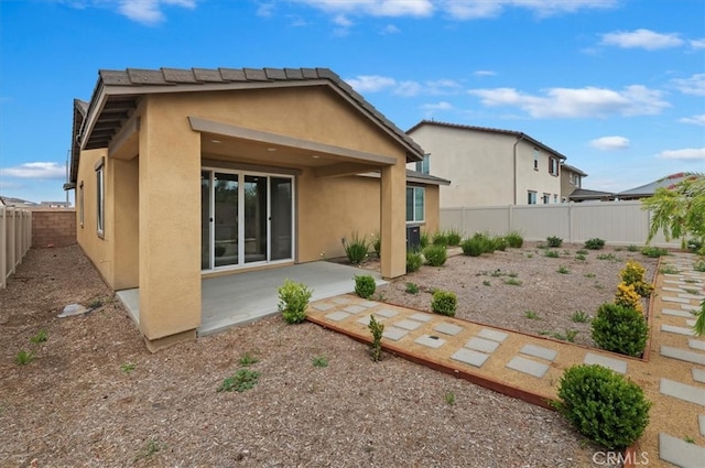 467 Daniella Way, Perris, CA 92570 - rear view of house with stucco siding, a patio area, and a fenced backyard