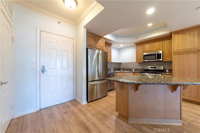 1437 Lomita Blvd Unit 227, Harbor City, CA 90710 - kitchen featuring crown molding, a breakfast bar, tasteful backsplash, a sink, and stainless steel appliances