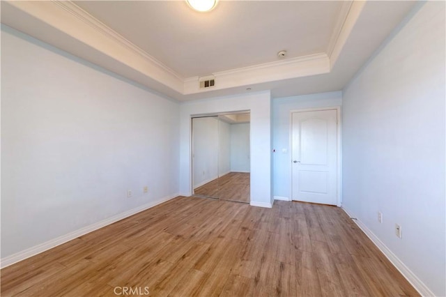 1437 Lomita Blvd Unit 227, Harbor City, CA 90710 - unfurnished bedroom with crown molding, a raised ceiling, light wood-style flooring, visible vents, and a closet