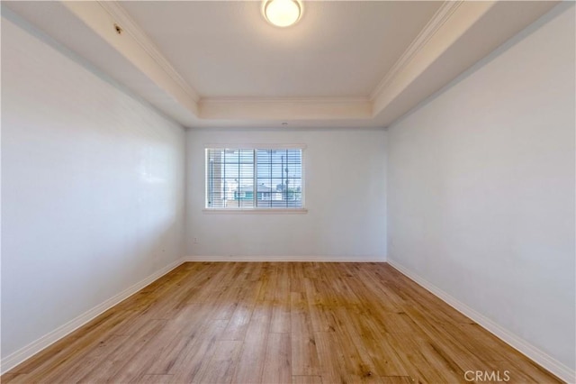 1437 Lomita Blvd Unit 227, Harbor City, CA 90710 - unfurnished room featuring crown molding, baseboards, a raised ceiling, and light wood-type flooring