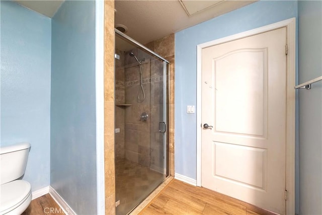 1437 Lomita Blvd Unit 227, Harbor City, CA 90710 - bathroom with baseboards, a shower stall, toilet, and wood finished floors