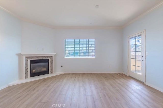 1437 Lomita Blvd Unit 227, Harbor City, CA 90710 - unfurnished living room with crown molding, a high end fireplace, baseboards, and light wood-style floors