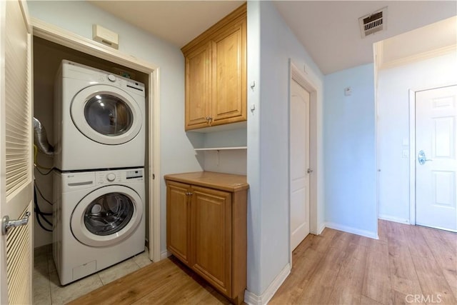 1437 Lomita Blvd Unit 227, Harbor City, CA 90710 - clothes washing area featuring visible vents, stacked washer and dryer, laundry area, baseboards, and light wood finished floors