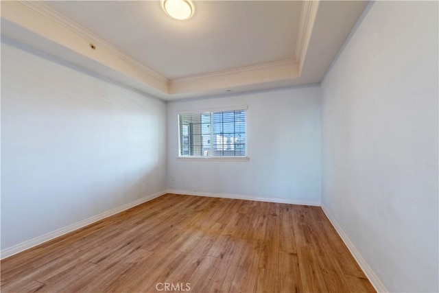 1437 Lomita Blvd Unit 227, Harbor City, CA 90710 - unfurnished room featuring baseboards, ornamental molding, light wood-style flooring, and a raised ceiling