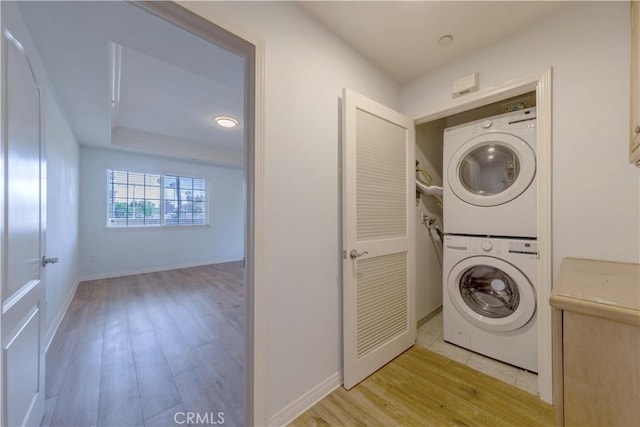 1437 Lomita Blvd Unit 227, Harbor City, CA 90710 - laundry room with baseboards, stacked washer and dryer, laundry area, and wood finished floors