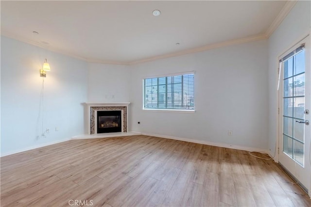 1437 Lomita Blvd Unit 227, Harbor City, CA 90710 - unfurnished living room featuring crown molding, a premium fireplace, baseboards, and light wood finished floors