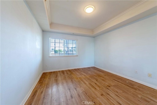 1437 Lomita Blvd Unit 227, Harbor City, CA 90710 - unfurnished room featuring crown molding, baseboards, a tray ceiling, and light wood-type flooring