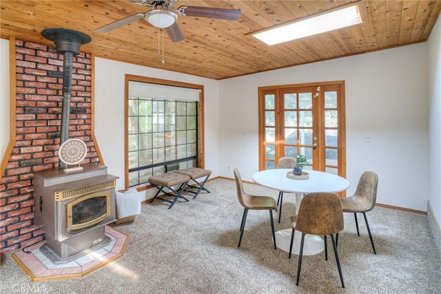 12 Linda Loma Dr, Oroville, CA 95966 - carpeted dining room with wood ceiling, a ceiling fan, a wood stove, and baseboards