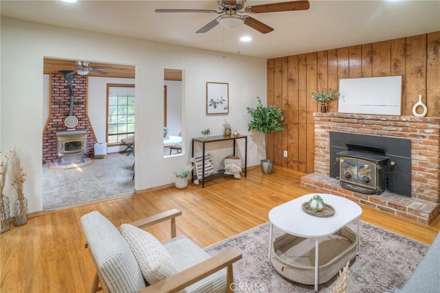 12 Linda Loma Dr, Oroville, CA 95966 - living area featuring a wood stove, ceiling fan, and baseboards