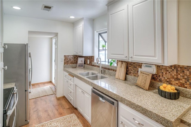 12 Linda Loma Dr, Oroville, CA 95966 - kitchen with a sink, light wood-style floors, visible vents, backsplash, and appliances with stainless steel finishes
