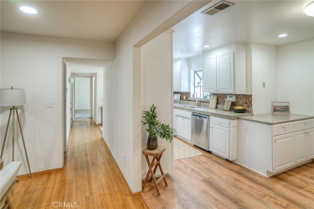 12 Linda Loma Dr, Oroville, CA 95966 - kitchen with light wood-style flooring, white cabinets, backsplash, dishwasher, and visible vents