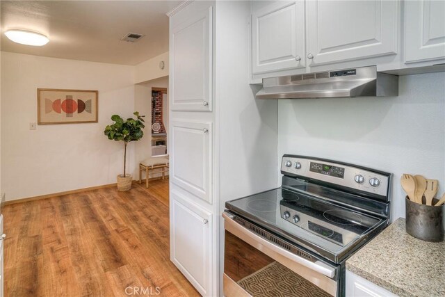 12 Linda Loma Dr, Oroville, CA 95966 - kitchen featuring white cabinets, visible vents, under cabinet range hood, and stainless steel range with electric cooktop