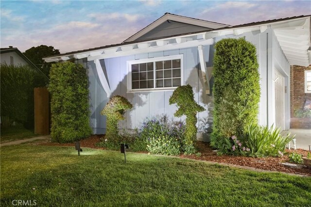 view of side of property with a lawn