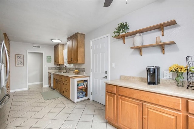 kitchen with open shelves, light countertops, dishwasher, a sink, and visible vents