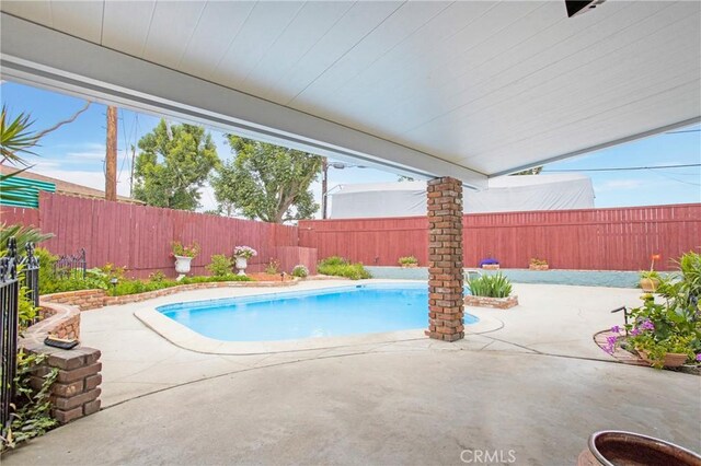 view of pool with a patio, a fenced in pool, and a fenced backyard